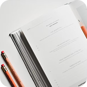 Open planner displaying daily gratitude and tasks, with pencils. Essential for tracking every annual obligation and goals.