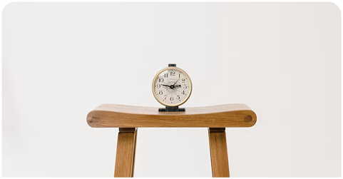 An antique alarm clock on a bench symbolizing efficient deadline tracking.
