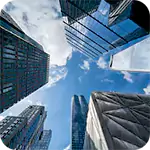 Modern skyscrapers soaring against a blue sky, symbolizing upward growth and Market Transparency in urban development.